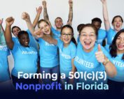 A diverse group of people with a light blue tshirt saying VOLUNTEER and the phrase "Forming a 501(c)(3) Nonprofit in Florida"