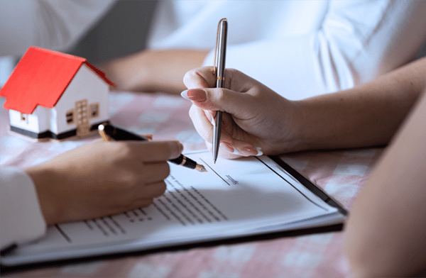 a woman and a men signing a document